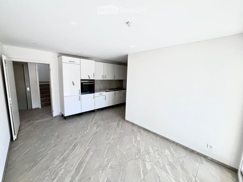 empty room, white walls, white cabinets, tiled floor, open door, kitchen area with oven