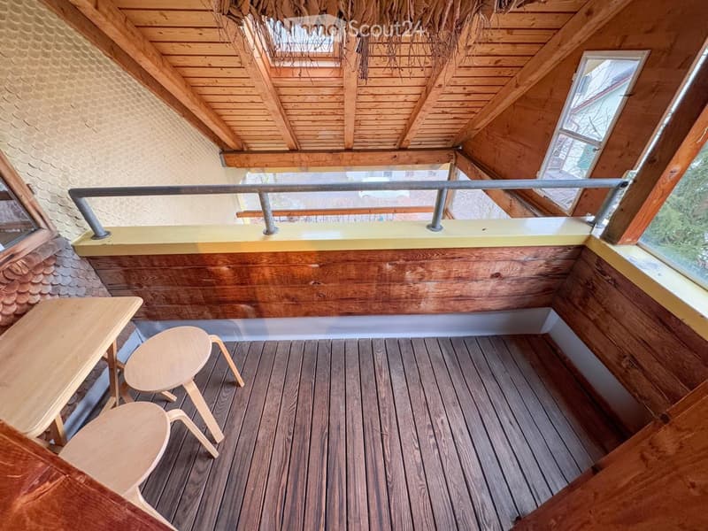wooden floor, wooden walls, wooden table, stools, metal railing, skylight