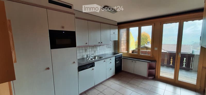 modern kitchen with white cabinets, tiled floor, sink, dishwasher, oven, balcony with view
