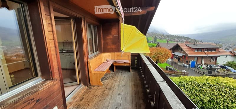 wooden bench, yellow umbrella, wooden floor, glass windows, kitchen area
