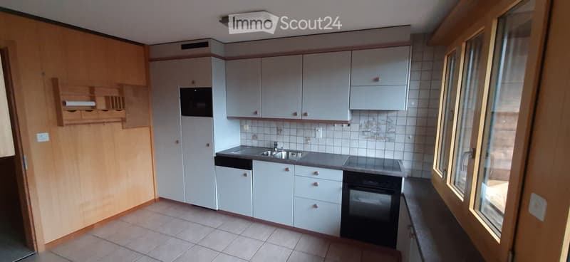 modern kitchen with white cabinets, tiled floor, sink, oven, dishwasher, washing machine