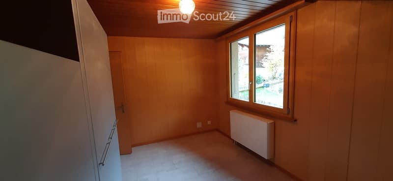 empty room, wooden walls, white floor, window, radiator