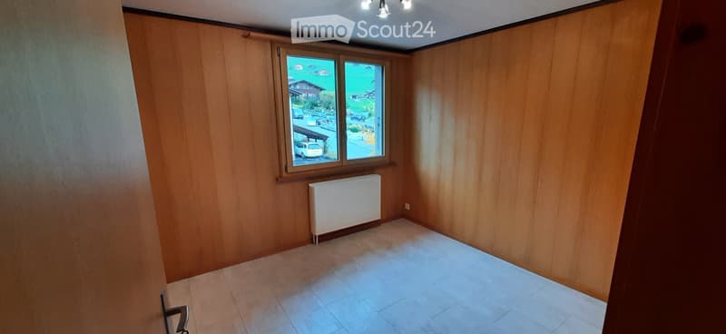 empty room, wooden walls, white floor, window, radiator