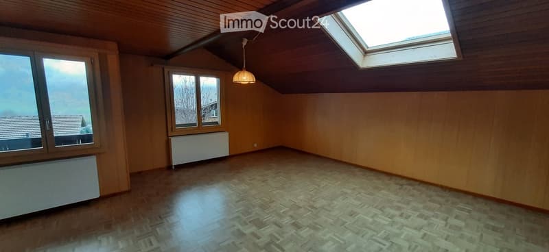 empty room, wooden walls, wooden floor, two windows, skylight, radiators