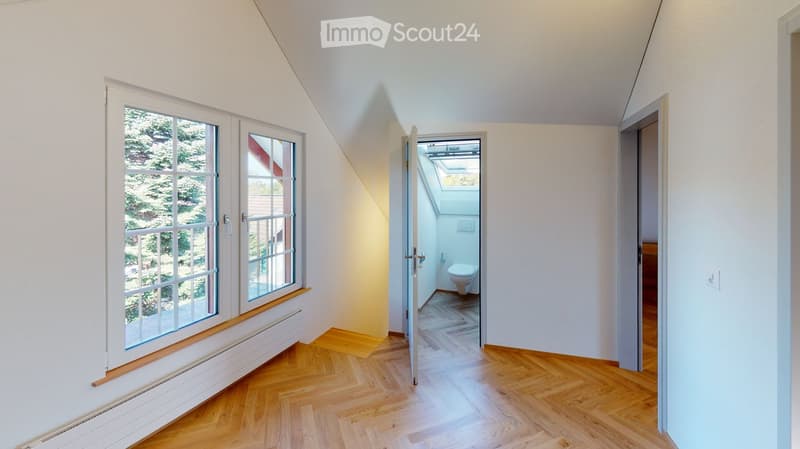 wooden floor, white walls, large window, open door, toilet