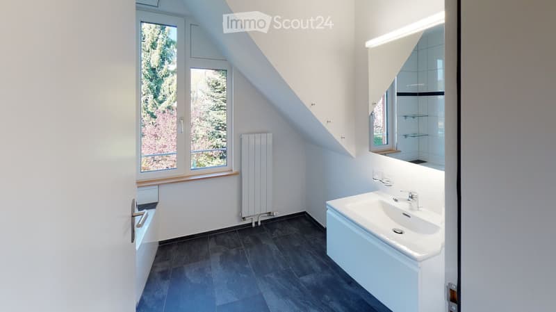 Bathroom with white sink, mirror, radiator, window, and tiled floor