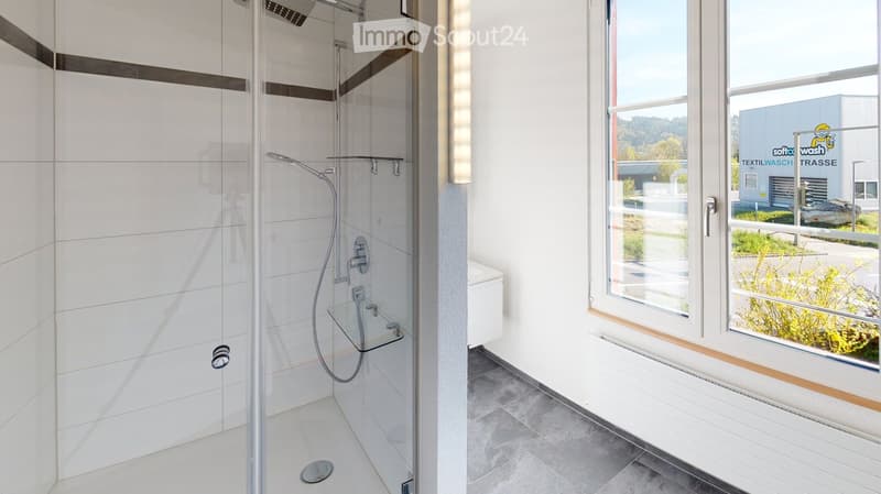 modern shower with glass door, white tiles, glass shelf, white toilet, window with view