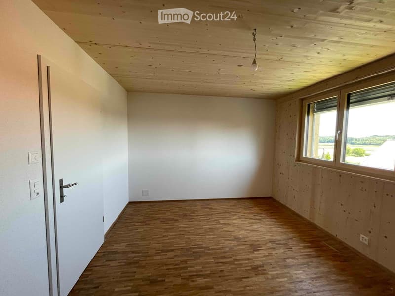 wooden floor, white walls, wooden ceiling, window, power outlets, small entrance door