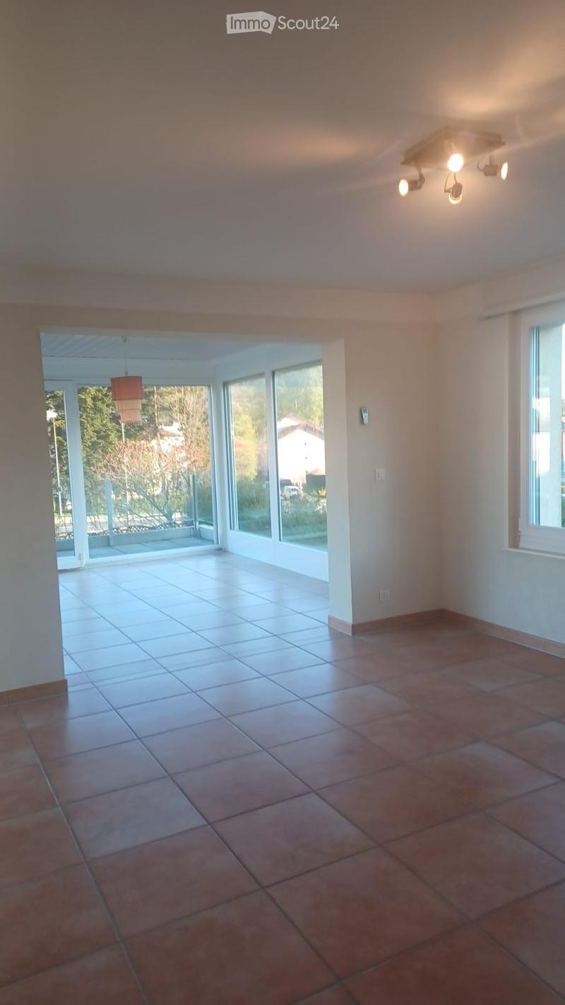 empty room, large windows, tiled floor, ceiling lights, sliding glass doors