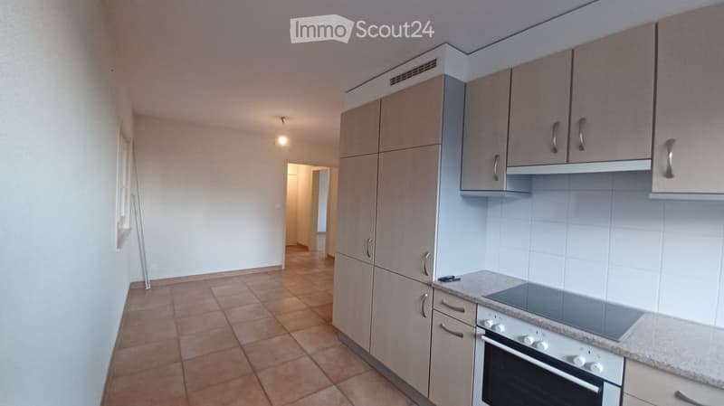 empty kitchen with tiled floor, cabinets, countertop, oven, and dishwasher