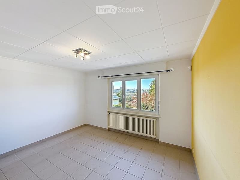 empty room, white walls, tiled floor, ceiling light, window, radiator