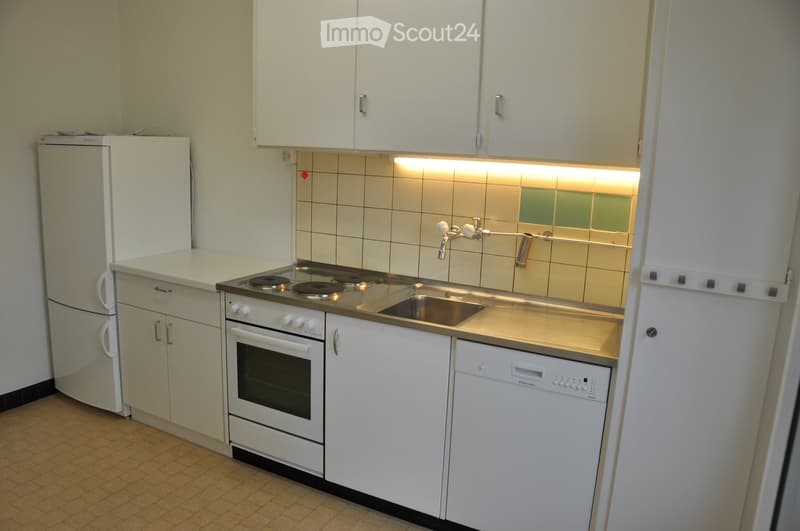 Kitchen. Compact kitchen with white cabinets, a refrigerator, a four-burner electric stove, an oven, a dishwasher, and a sink with a faucet.