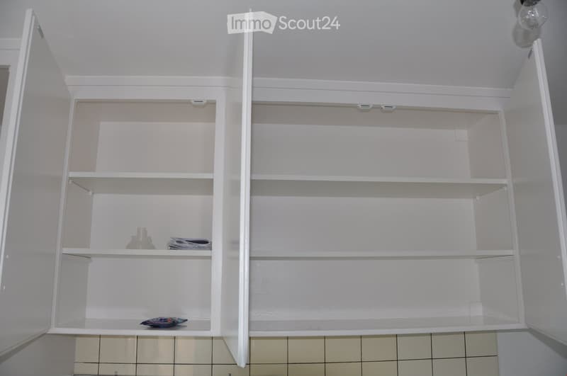 3 fully open white kitchen cabinets