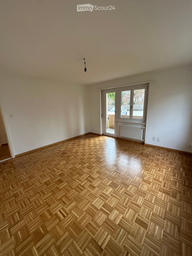 empty room, wooden floor, white walls, sliding doors to terrace