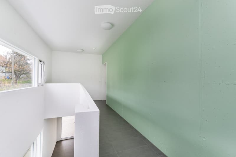 white walls, green wall, tiled floor, white ceiling, windows, light fixtures