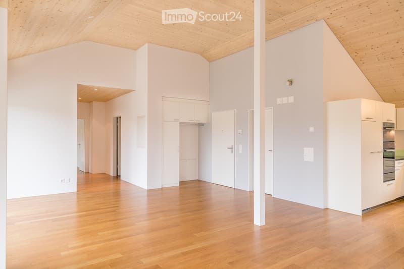 empty room, wooden floor, white walls, wooden ceiling, kitchen area with oven and cabinets