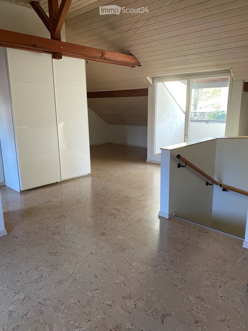 empty room with wooden ceiling, white storage cabinets, glass window, tiled floor