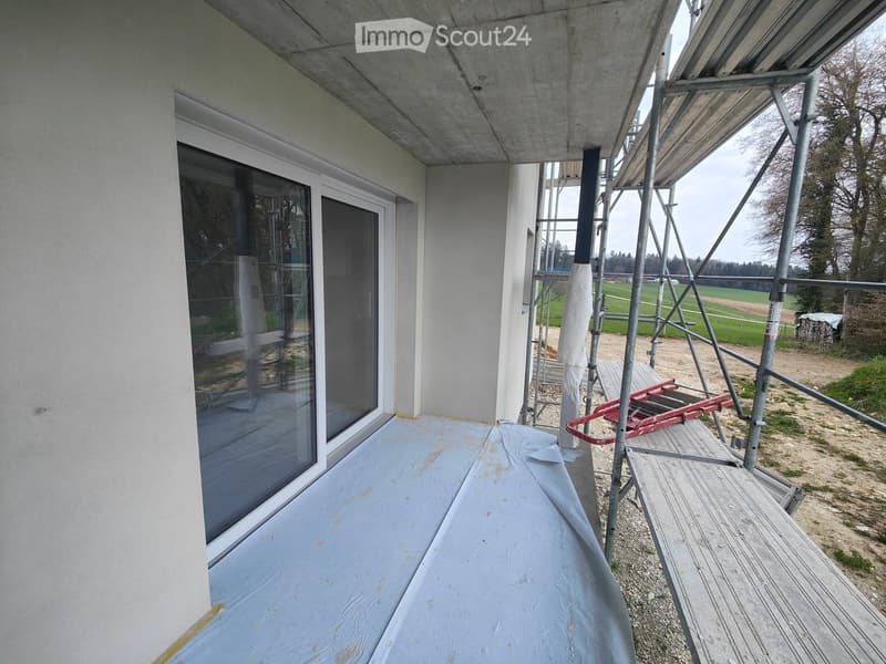 white exterior wall, glass sliding doors, balcony, scaffolding