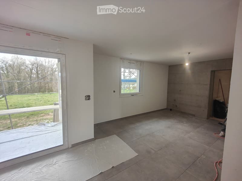 Empty room with white walls, tiled floor, glass door, small window, and a bench outside