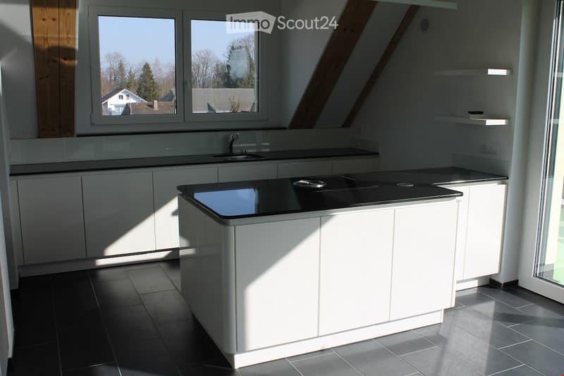 Kitchen. Modern kitchen with white cabinets, black countertops, and a sink with a faucet.