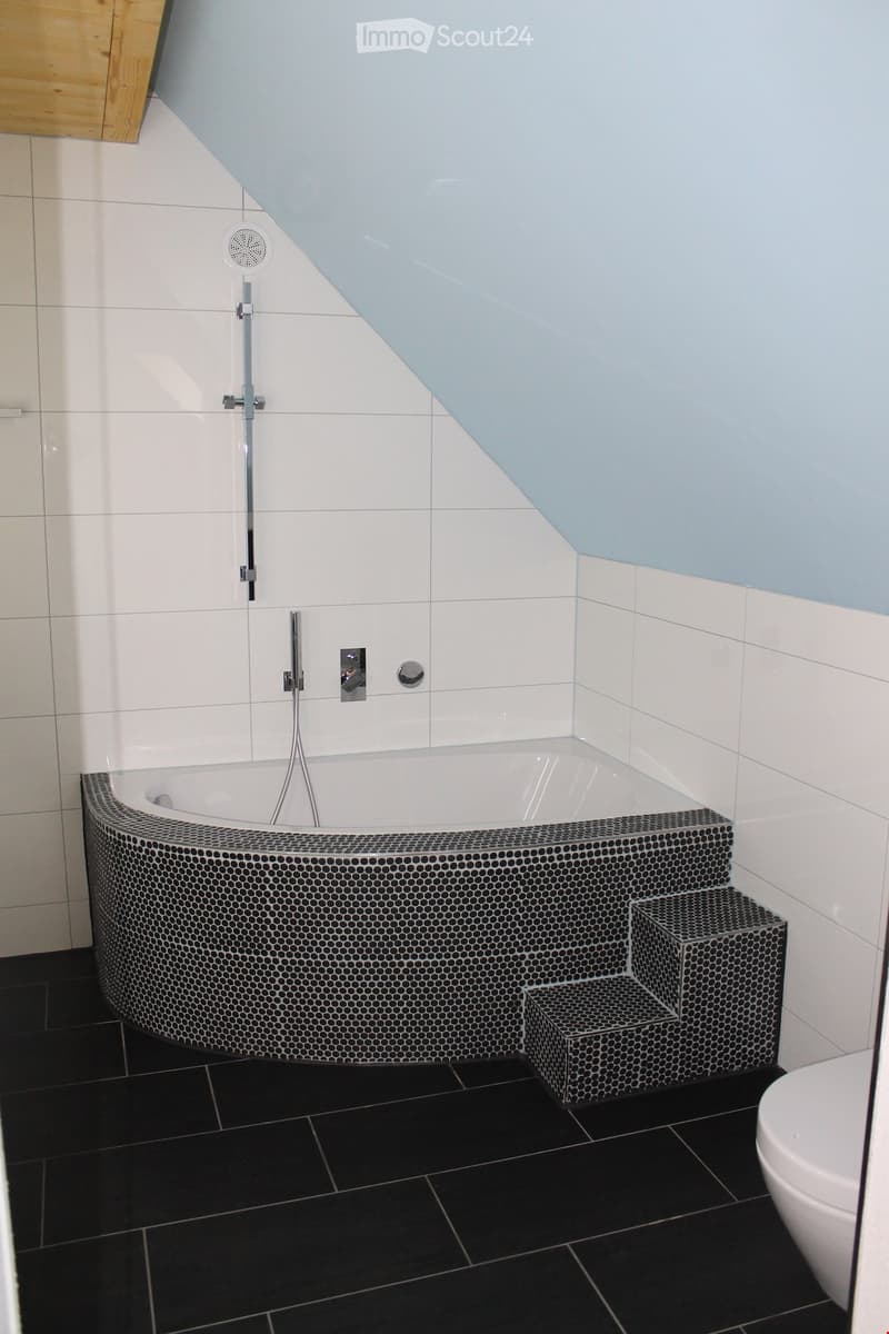 Bathroom. Bathroom with a corner bathtub, shower head, faucet, and white toilet.
