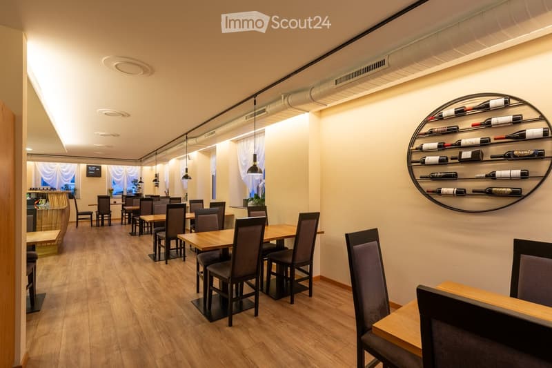 Wooden floor, dining tables, chairs, counter, wine rack