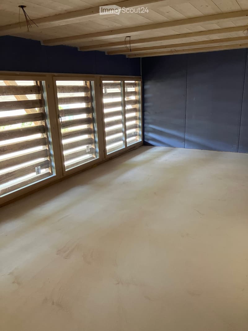 Unfurnished Room. Completely empty room with bare walls, wooden ceiling, and white floor. Three large windows with wooden shutters.