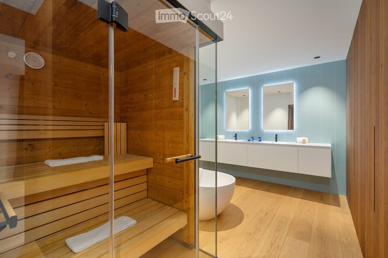 sauna room, wooden bench, glass door, blue tile wall, white vanity, round white bathtub