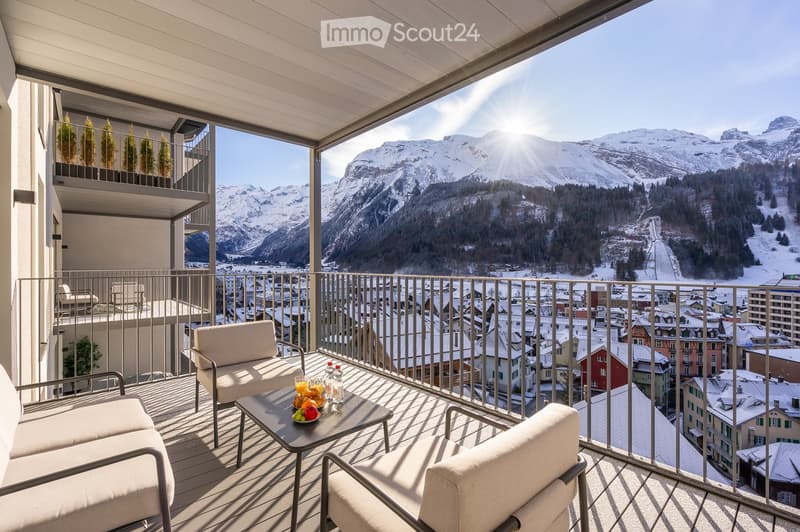 Balcony with a table, chairs, mountain view
