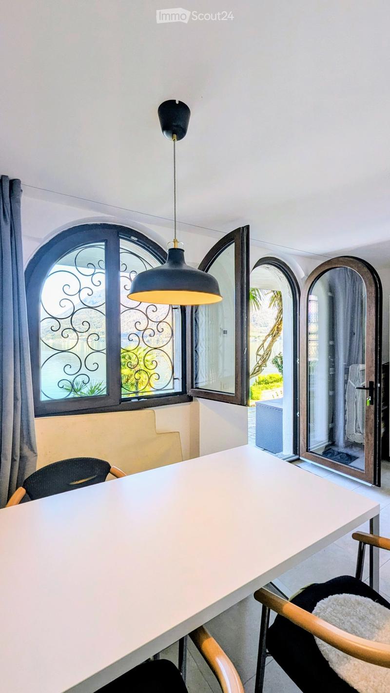 Dining area with a table, chairs, and a window with a view of the outside