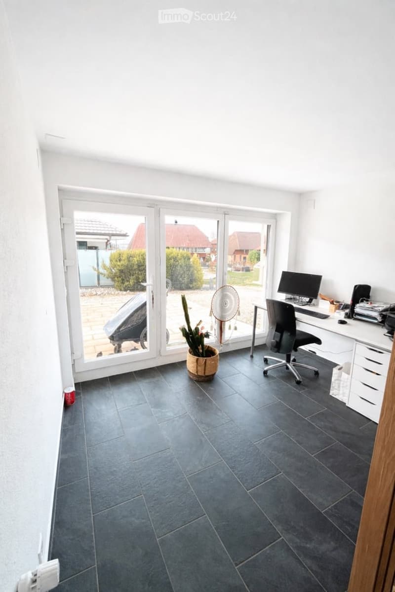 empty room, white walls, black tiles, sliding glass doors, desk, chair, computer, fan, potted plant