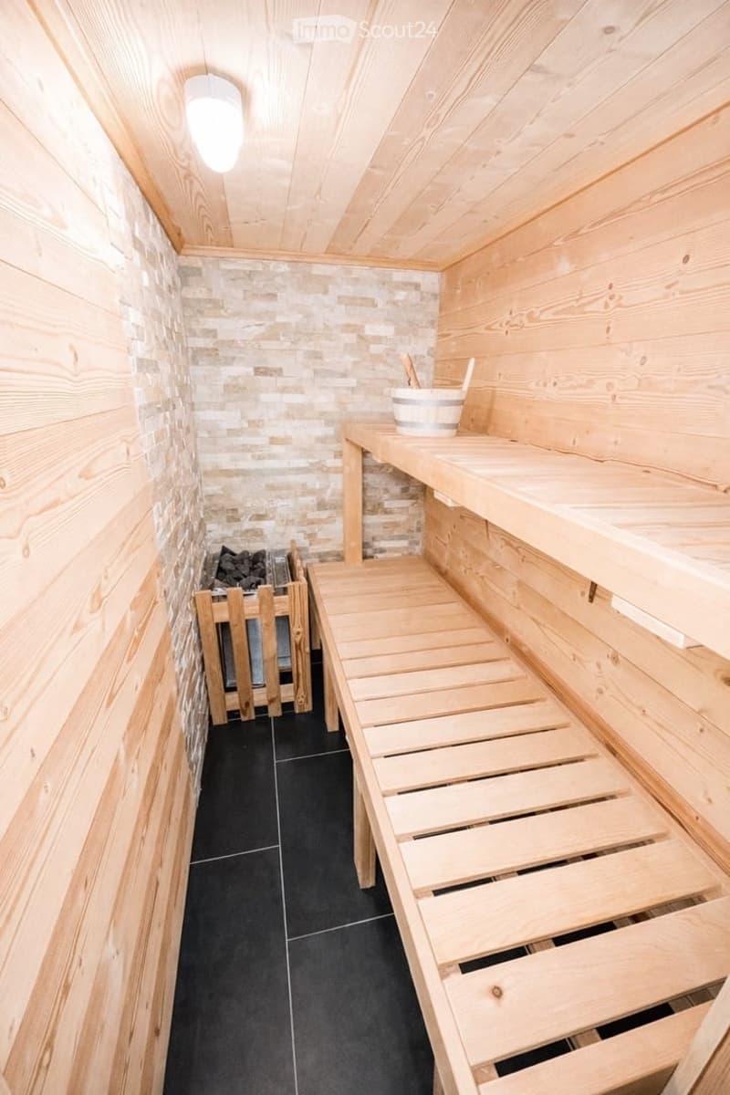 wooden walls, wooden benches, black tiles, wooden bucket, fireplace