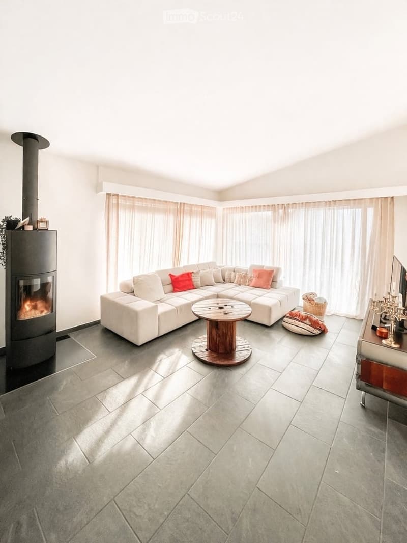 modern living room, white couch, fireplace, wooden table, tiled floor, large windows