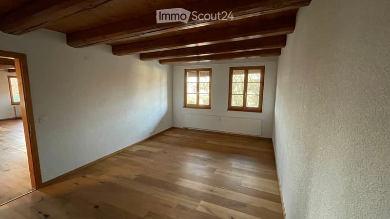 empty room, hardwood floors, two windows, white painted wall, wooden ceiling