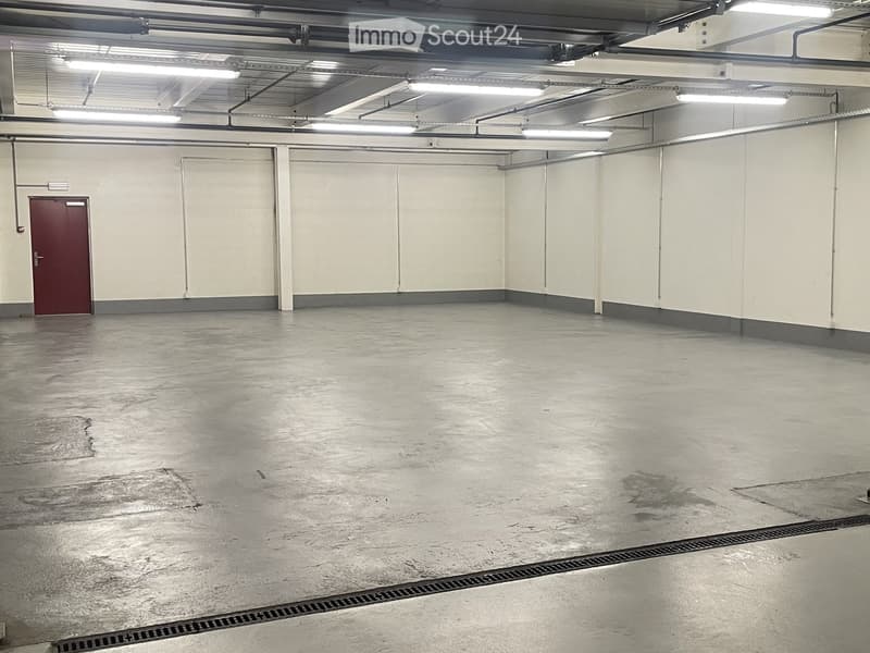 Unfurnished Room. Empty room with concrete floor, white walls, and metal ceiling with fluorescent lights.