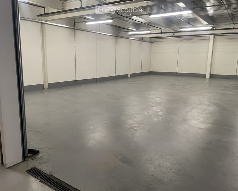 Unfurnished Room. An empty room with white walls, gray floor, and metal beams on the ceiling. There are no visible objects or furniture.