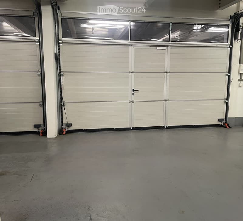 Other. {"visible_features":[],"type":"Garage","objects":[],"description":"Empty garage with two large white roll-up doors, a white pillar, and a concrete floor.","localized_descriptions":{"EN":"Empty garage with two large white roll-up doors, a white pill