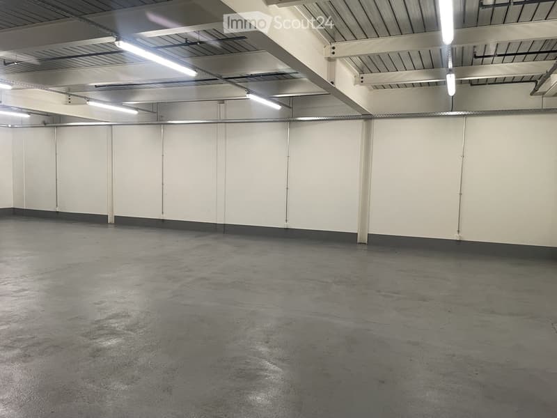 Unfurnished Room. Empty room with white walls, gray floor, and metal beams on the ceiling. There are no visible objects or furniture.