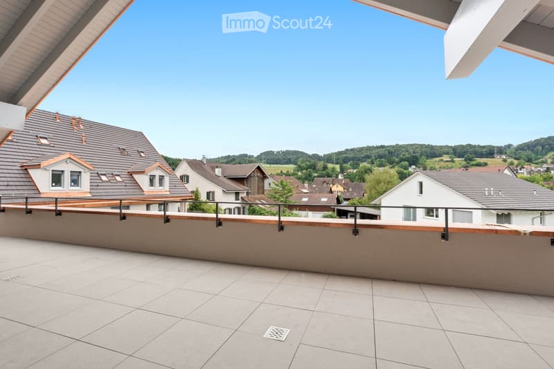 Balcony with tiled floor, wooden railing, and a view of a residential neighborhood with houses and greenery.