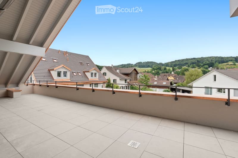 Balcony with tiled floor, wooden railing, and a view of a residential neighborhood with houses and greenery.