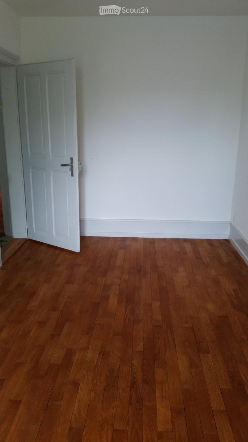 Completely empty room with bare walls and wooden floor. No furniture or equipment.