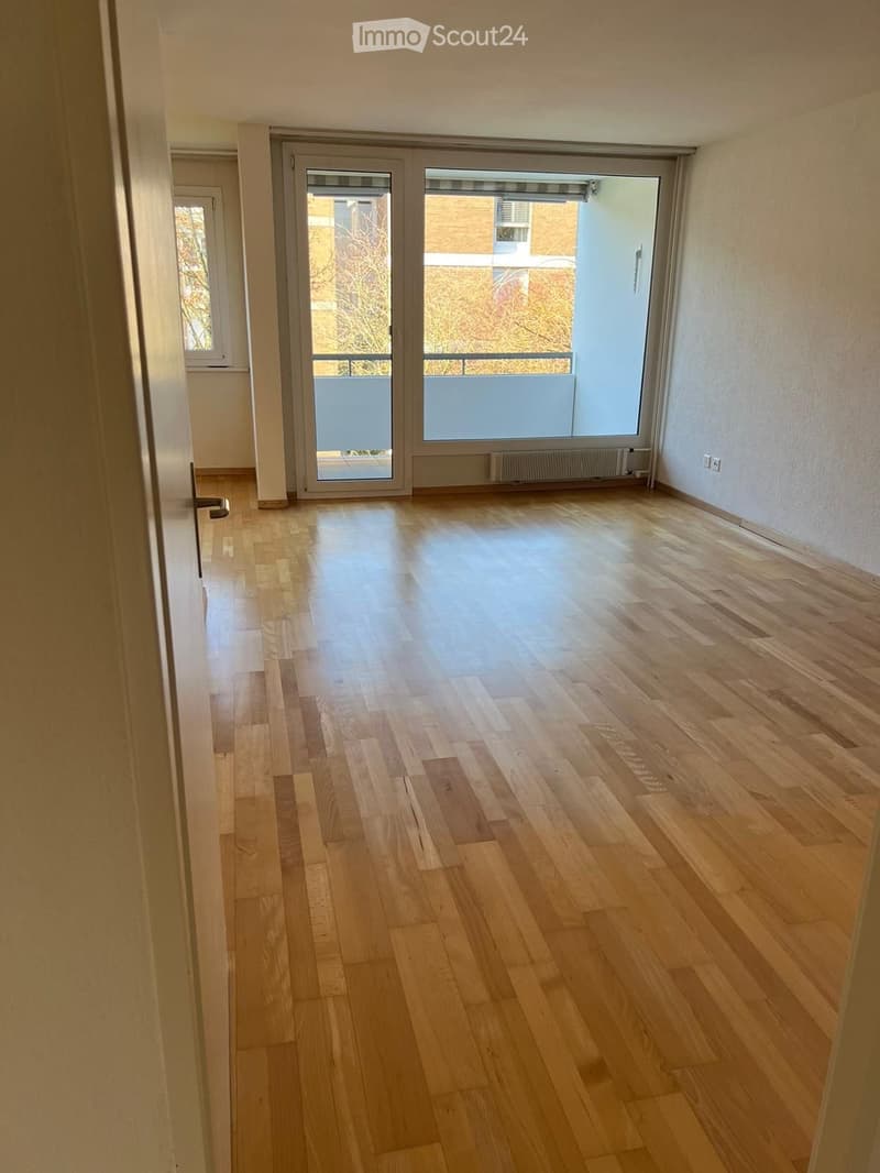 empty room, wooden floor, sliding glass doors, balcony, white walls, white ceiling
