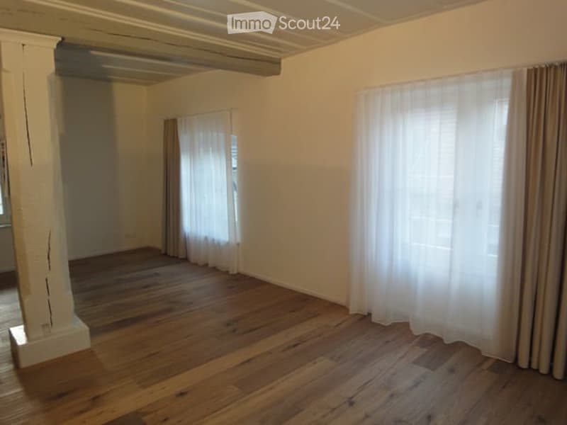 wooden floor, white walls, white curtains