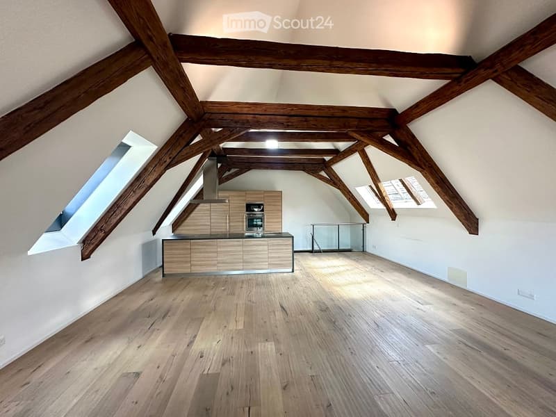 large wooden ceiling beams, wooden floor, kitchen island with countertop, large windows, kitchen appliances