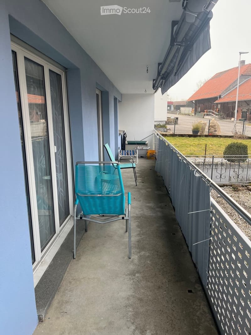 Balcony / Terrace. Balcony with concrete floor, metal railing, and two turquoise chairs.