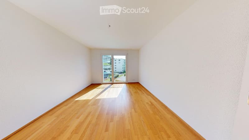empty room with sliding glass door to balcony, hardwood floors, white walls