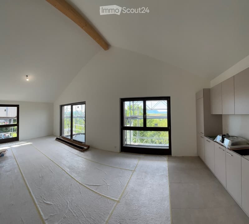 Furnished Room. Bright, open room with white tiled floors, large windows, and kitchen cabinets on one side. The space is unfurnished except for the kitchen area.