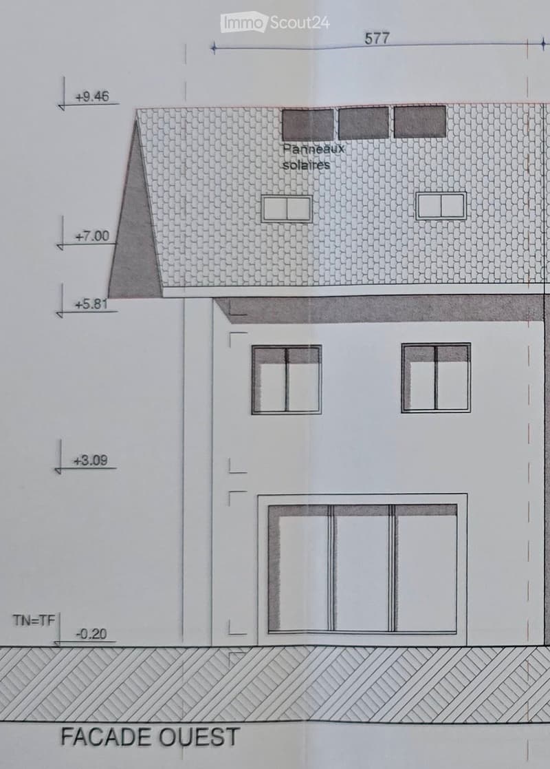 Facade of a house with solar panels on the roof, two windows on the first floor, two windows on the second floor, and a large window on the ground floor.