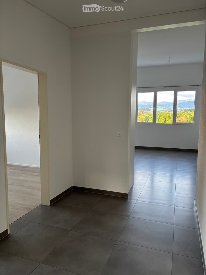 Unfurnished Room. Empty room with tiled floor, large windows, and a view of the landscape. No furniture or equipment present.