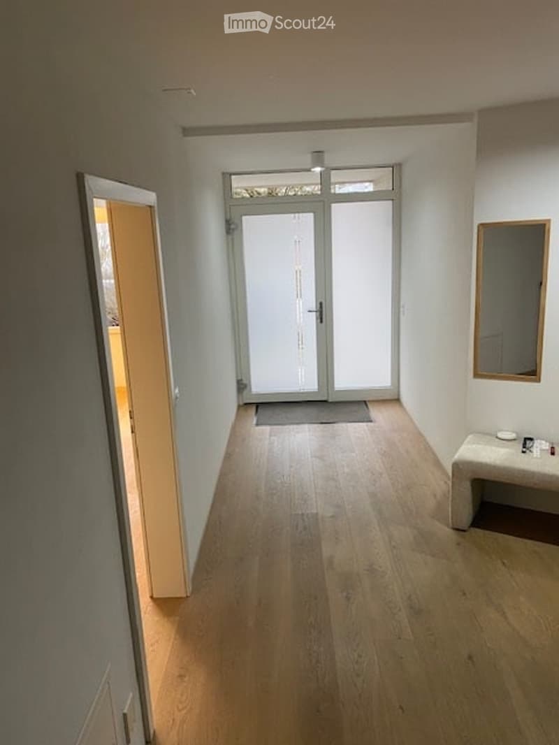 light wood floor, white walls, glass doors, mirror on wall